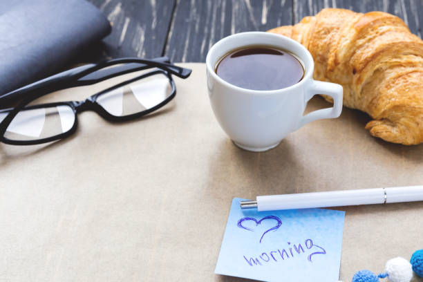 istock French croissant, glasses, coffee and notebook. Workplace concep 639450504