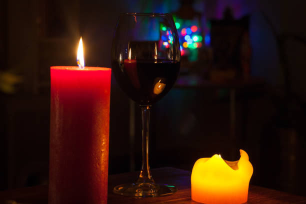 istock glass of wine with candles 639453490