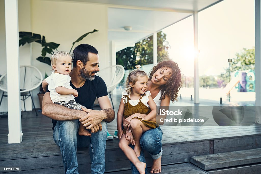 Our children are our most precious possessions Shot of a happy young family spending the weekend together at home Family Stock Photo