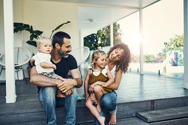 Our children are our most precious possessions Shot of a happy young family spending the weekend together at home common couple men outdoors stock pictures, royalty-free photos & images