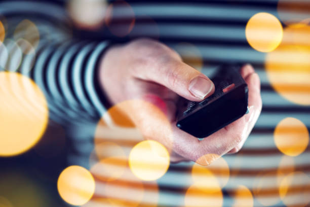 istock Female hand with television remote control 639454312