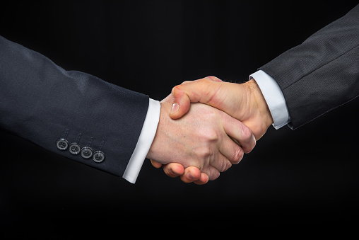 Photo of handshake of business partners after striking deal 