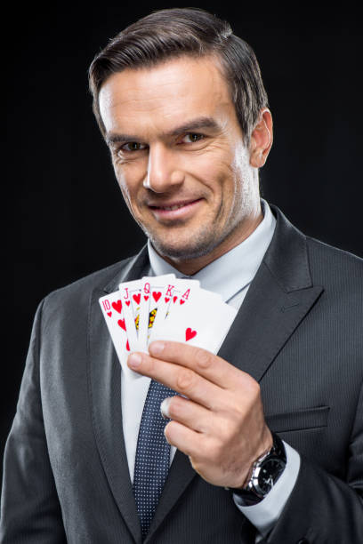 istock Man holding playing cards 639454644