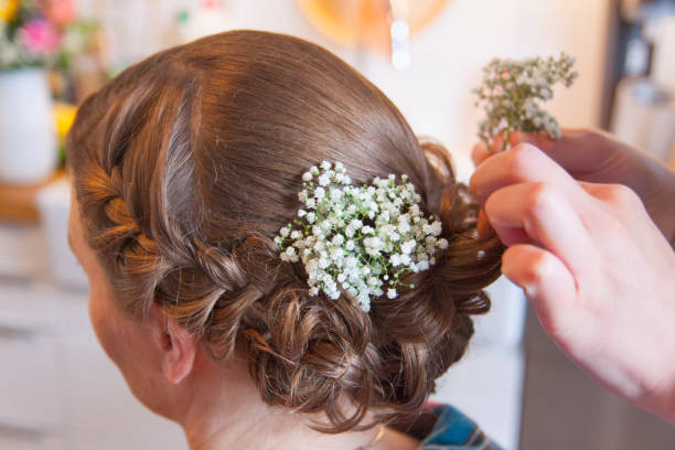 A bridal hairstyle is created A bridal hairstyle is created hochsteckfrisur stock pictures, royalty-free photos & images