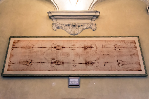 Turin, Italy - December 31, 2015: Royal Church of San Lorenzo interior with a copy of the holy Shroud in Turin, Italy. The Sacra sindone is believed to be the burial shroud of Jesus of Nazareth.