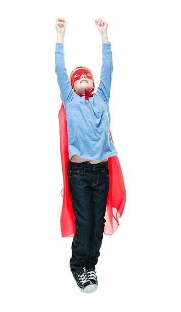 istock Smiling little superhero jumping and cheering 639456832