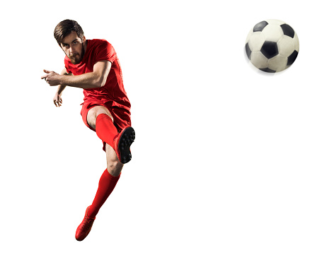 Full length portrait of professional soccer player contemplating perfect kicking of ball. Footballer's focus, unwavering and determined. Concept of game, sport, recreation, active lifestyle.