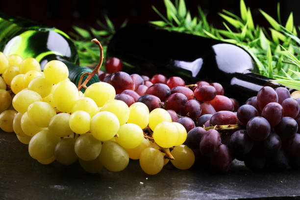 istock Bottle of white wine, grape and corks 639460196