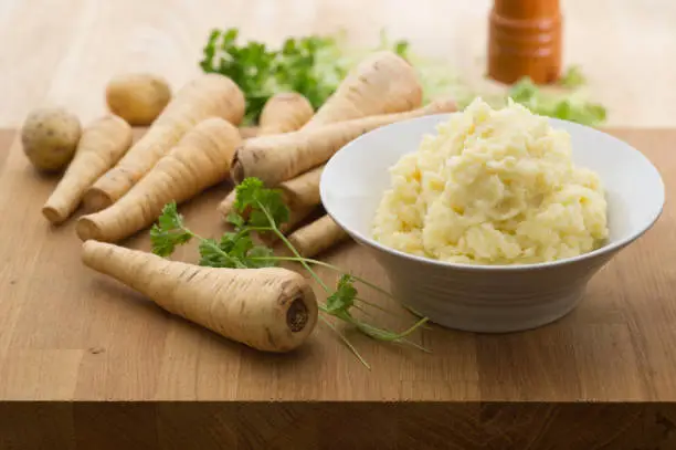 Homemade parsnip and potato mash with parsley.