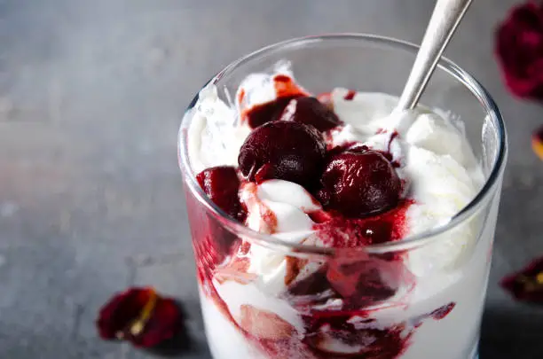 Photo of Sundae Ice cream with cherry in chocolate topping, and dried