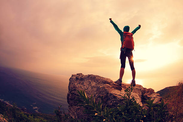 istock successful hiker hiking on seaside mountain peak 639463380