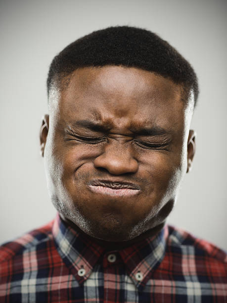 Close-up of angry man puffing cheeks