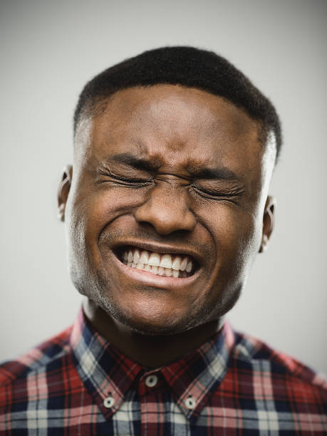 istock Angry man with eyes closed clenching teeth 639465858
