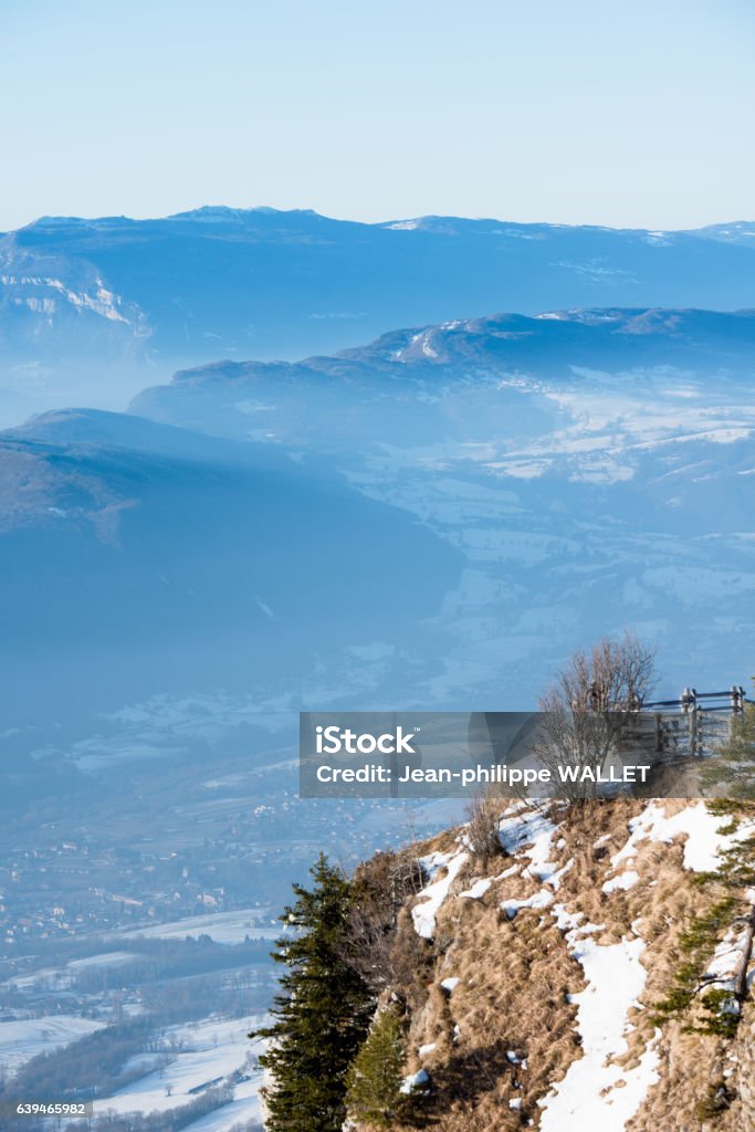 french alps winter panoramic view landscape blue cloudy mountain background beautiful french alps winter panoramic aerial view landscape with a fantastic blue haze cloudy mountain background French Alps Stock Photo