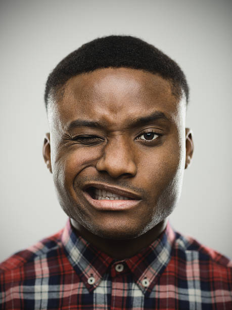 istock Close-up portrait of man winking 639466130