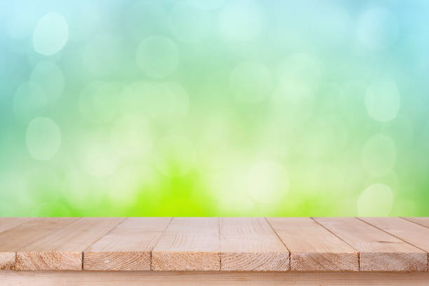 istock brown wood table top on bokeh abstract green background 639466404
