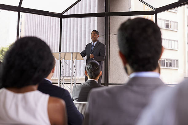 istock Black businessman presenting business seminar to an audience 639466622