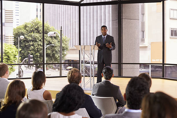istock Black businessman presenting seminar gesturing to audience 639466648