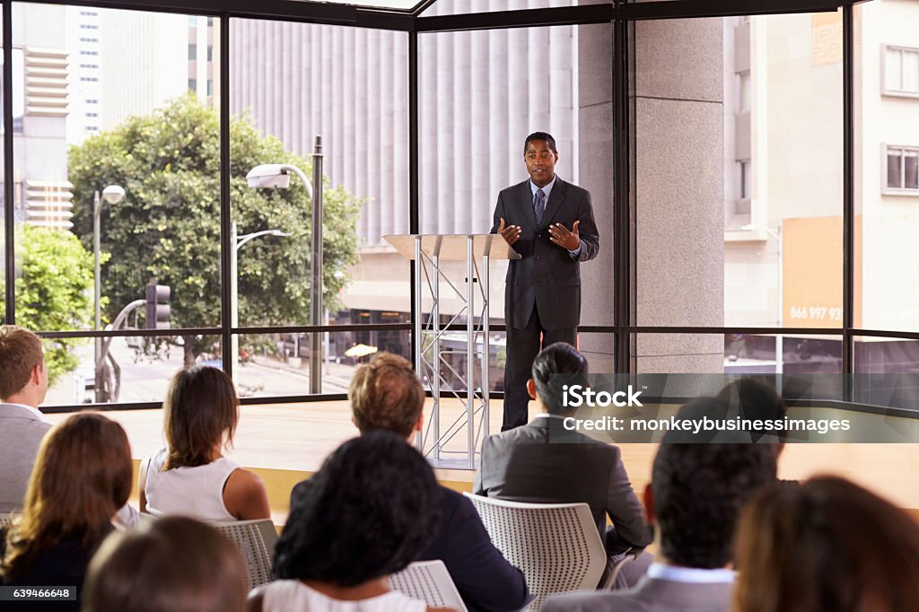 Black businessman presenting seminar gesturing to audience Public Speaker Stock Photo