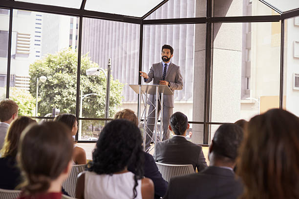 istock Hispanic man presenting business seminar to audience 639466674