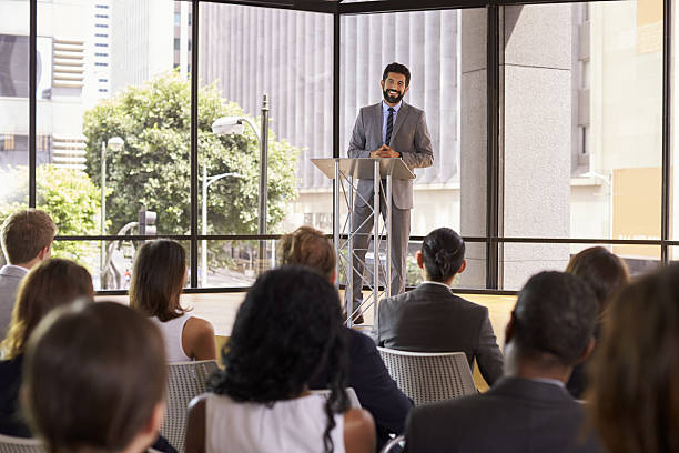 istock Hispanic man presenting business seminar smiling to audience 639466682