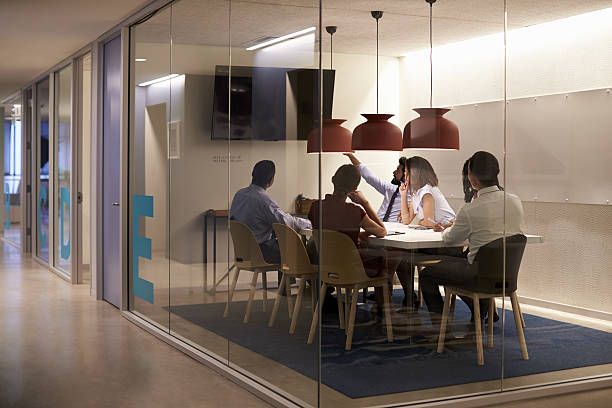istock Corporate business team using AV display in meeting cubicle 639467672