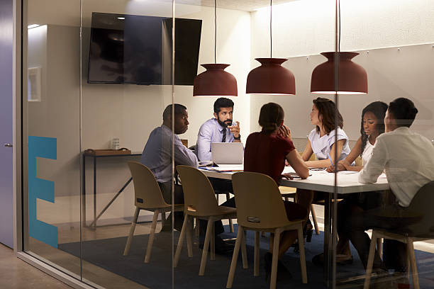 istock Corporate team at table in a meeting room cubicle, 639467766