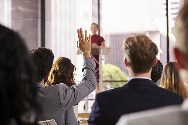 istock Presenter at business seminar takes a question from audience 639467992
