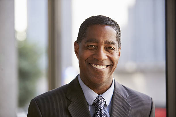 istock Middle aged black businessman smiling to camera 639468194