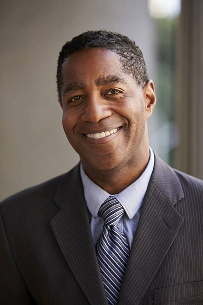 istock Middle aged black businessman smiling to camera, vertical 639468204