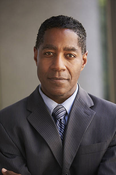 istock Middle aged black businessman looking at camera, vertical 639468268