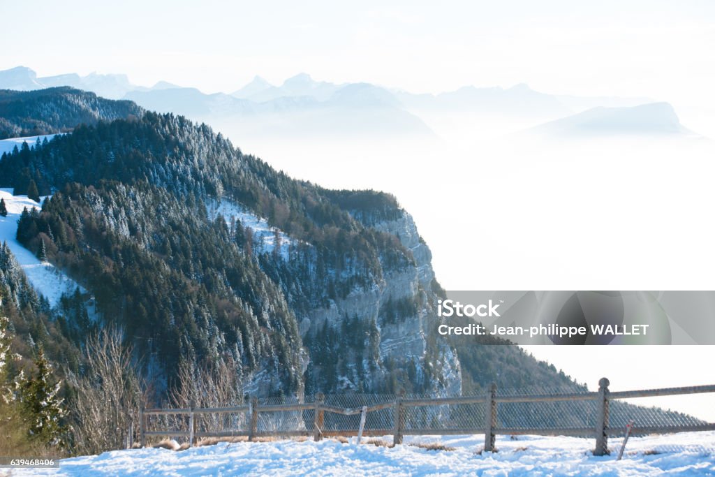 french alps winter panoramic view landscape blue cloudy mountain background beautiful french alps winter panoramic aerial view landscape with a fantastic blue haze cloudy mountain background Adventure Stock Photo