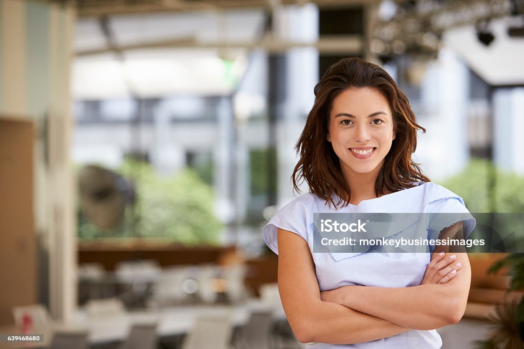 Portrait of young mixed race businesswoman with arms crossed Women Stock Photo