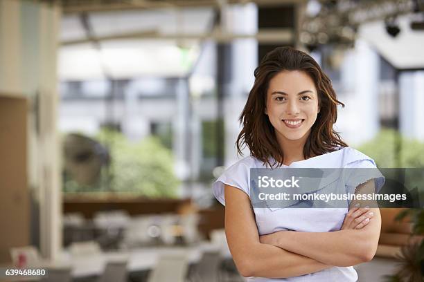 Portrait Of Young Mixed Race Businesswoman With Arms Crossed Stock Photo - Download Image Now