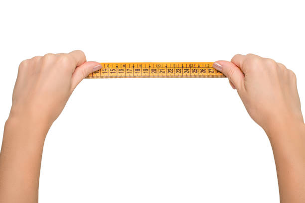 istock Humans arms holding tape measure on  white background 639470184