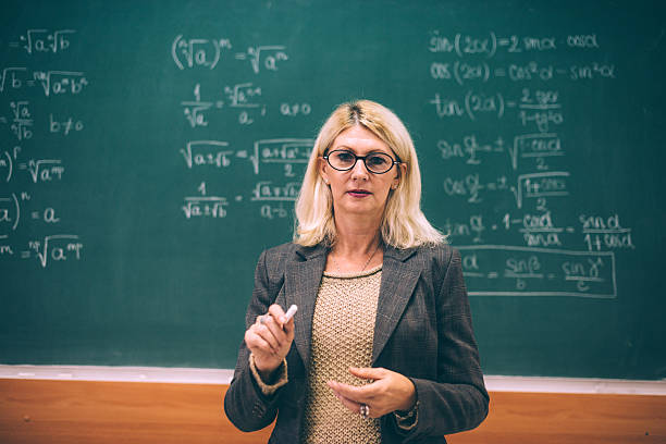 istock Intelligent female math professor in classroom 639471480