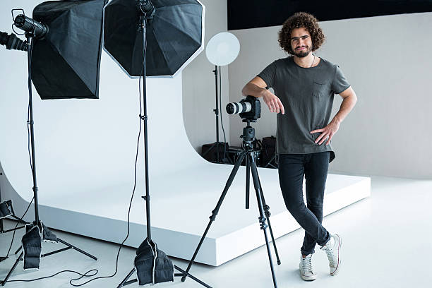 istock Happy male photographer standing in studio 639473830