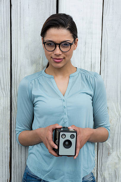 istock Female photographer with old fashioned camera 639473938