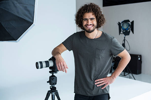 istock Happy male photographer standing in studio 639473966