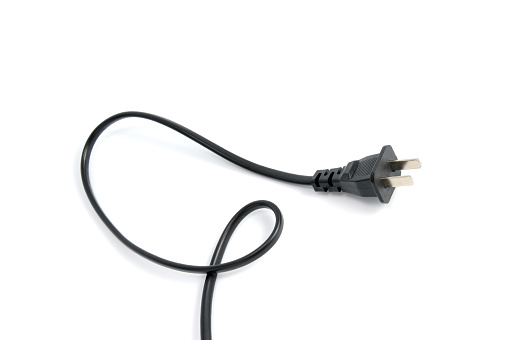 Black electrical plug and electrical cord isolated on white background