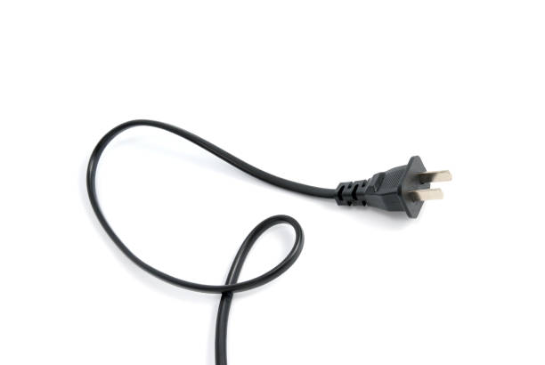 Electrical plug isolated on white background Black electrical plug and electrical cord isolated on white background connection block computer cable electronics industry electricity stock pictures, royalty-free photos & images