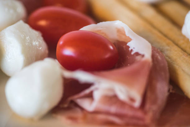 Mozzarella, tomatos, ham and grissini