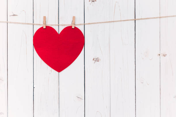 istock Blank red heart hanging on white wood with space 639479874