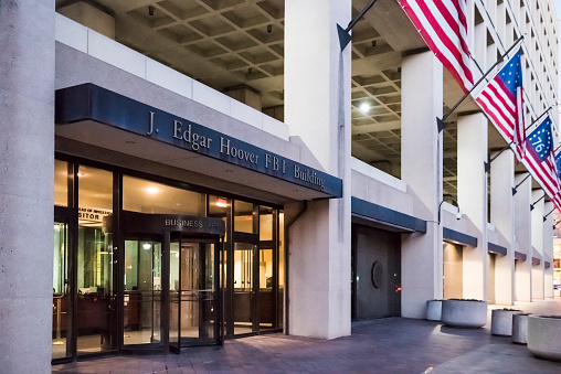 Washington Dc, United States - December 29, 2016: FBI, Federal Bureau of Investigation Headquarters, on Pennsylvania avenue sign with American flags