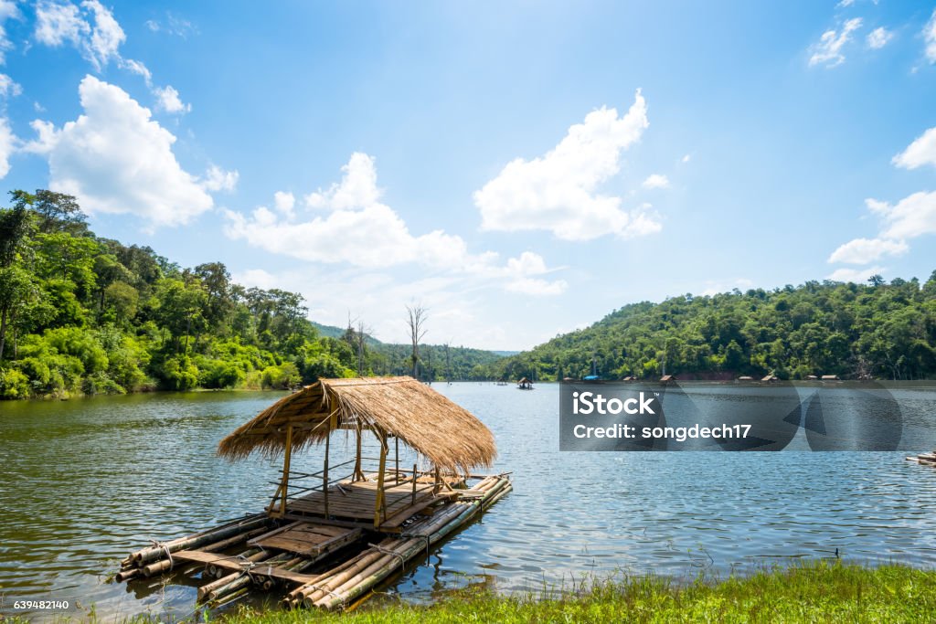 Bamboo raft, floating house in lake Bamboo raft floating in lake with mountain background Bamboo - Material Stock Photo