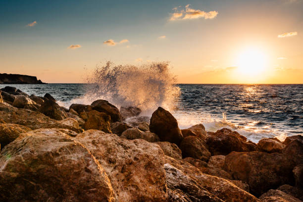 istock Waves crashing against rock 639485348