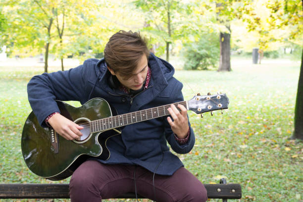istock Young man with an acoustic guitar 639486866