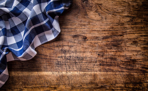 Top view of checkered tablecloth  on empty wooden table