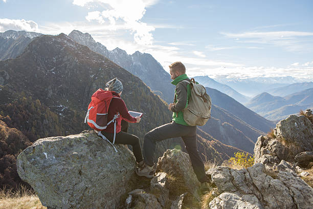 istock Two young hikers looking at digital tablet 639489538