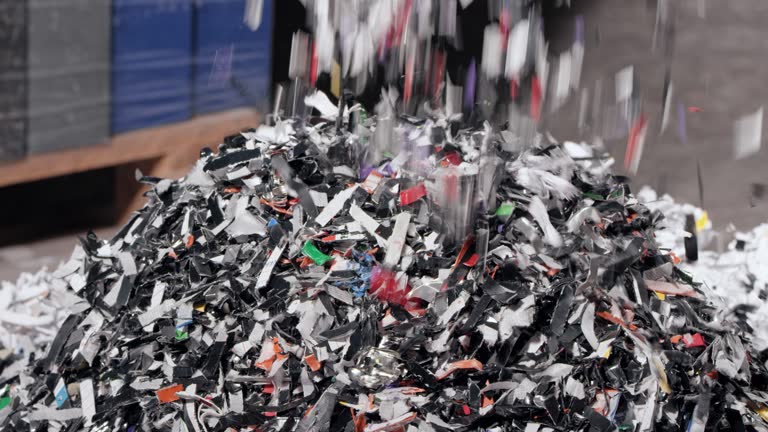 SLO MO Shredded plastic falling down from the conveyor belt